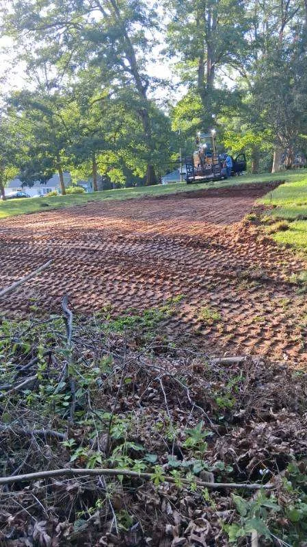 Excavated pool area in Stoneville with equipment beyond the rough-graded soil